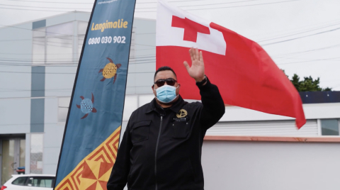 Man waving and wearing face mask